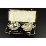 A PAIR OF LATE VICTORIAN SILVER BON BON DISHES, of wavy oval form, embossed with foliate scrolls,