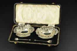 A PAIR OF LATE VICTORIAN SILVER BON BON DISHES, of wavy oval form, embossed with foliate scrolls,