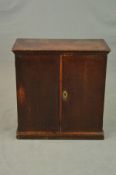 A GEORGE III OAK DOUBLE DOOR CUPBOARD, moulded edge above plain doors, replacement brass escutcheon,