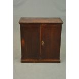 A GEORGE III OAK DOUBLE DOOR CUPBOARD, moulded edge above plain doors, replacement brass escutcheon,