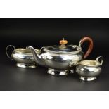 A GEORGE V OVAL SILVER THREE PIECE TEA SERVICE, ribbed top rim, 'C' scroll handles, flared foot rim,