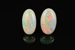 TWO OPAL OVAL CABOCHON CUT STONES, one measuring 24mm x 15mm, the other 23.7mm x 13.0mm, total