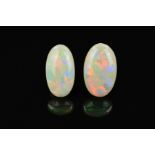 TWO OPAL OVAL CABOCHON CUT STONES, one measuring 24mm x 15mm, the other 23.7mm x 13.0mm, total