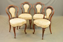 A SET OF FOUR VICTORIAN WALNUT DINING CHAIRS, the serpentine top rail above central foliate