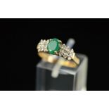 A MODERN EMERALD AND DIAMOND DRESS RING, ring size M, stamped '10k', approximate gross weight 2.4