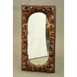 A LATE 19TH CENTURY CARVED OAK RECTANGULAR WALL MIRROR, gadrooned edge, foliate decoration with a