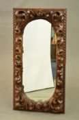 A LATE 19TH CENTURY CARVED OAK RECTANGULAR WALL MIRROR, gadrooned edge, foliate decoration with a