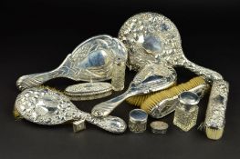 AN EDWARDIAN ART NOUVEAU SILVER BACKED DRESSING TABLE SET, embossed with peacocks, maker Henry