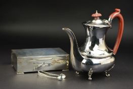 AN ELIZABETH II SILVER COFFEE POT, of oval form, bakelite fitments, husk decoration to band, on four