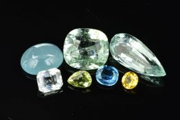 AN ASSORTMENT OF COLOURED BERYL GEMSTONES, to include yellow, green, white and dark blue aquamarine,