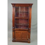 AN EARLY 19TH CENTURY MAHOGANY BOOKCASE, the moulded cornice above two glazed doors each with six