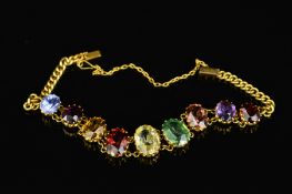 A MID 20TH CENTURY MULTI GEMSTONE GOLD BRACELET, oval mixed cut gemstones graduating in size from
