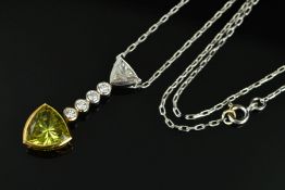 A MODERN 18CT GOLD SAPPHIRE AND DIAMOND PENDANT, a greenish yellow triangular cut sapphire (assessed
