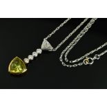 A MODERN 18CT GOLD SAPPHIRE AND DIAMOND PENDANT, a greenish yellow triangular cut sapphire (assessed