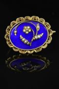 A MID VICTORIAN GOLD MEMORIAL BROOCH, blue enamel inlaid with floral seed pearl detail, oval shape