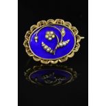 A MID VICTORIAN GOLD MEMORIAL BROOCH, blue enamel inlaid with floral seed pearl detail, oval shape