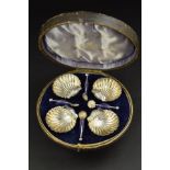 A LATE VICTORIAN CIRCULAR CASED SET OF FOUR SILVER SHELL SHAPED SALTS AND SPOONS, the salts on three