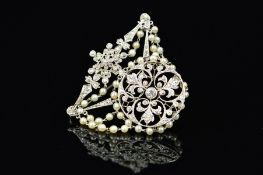 A BELLE EPOQUE PEARL AND DIAMOND BROOCH, an open work circular plaque with central old European