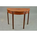 A GEORGE III WALNUT AND BOXWOOD STRUNG 'D' END FOLD OVER CARD TABLE, baize lined interior, on four