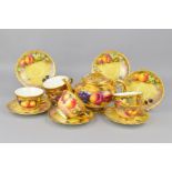 A ROYAL WORCESTER FRUIT STUDY PART TEASET, comprising teapot and cover, six tea cups and six