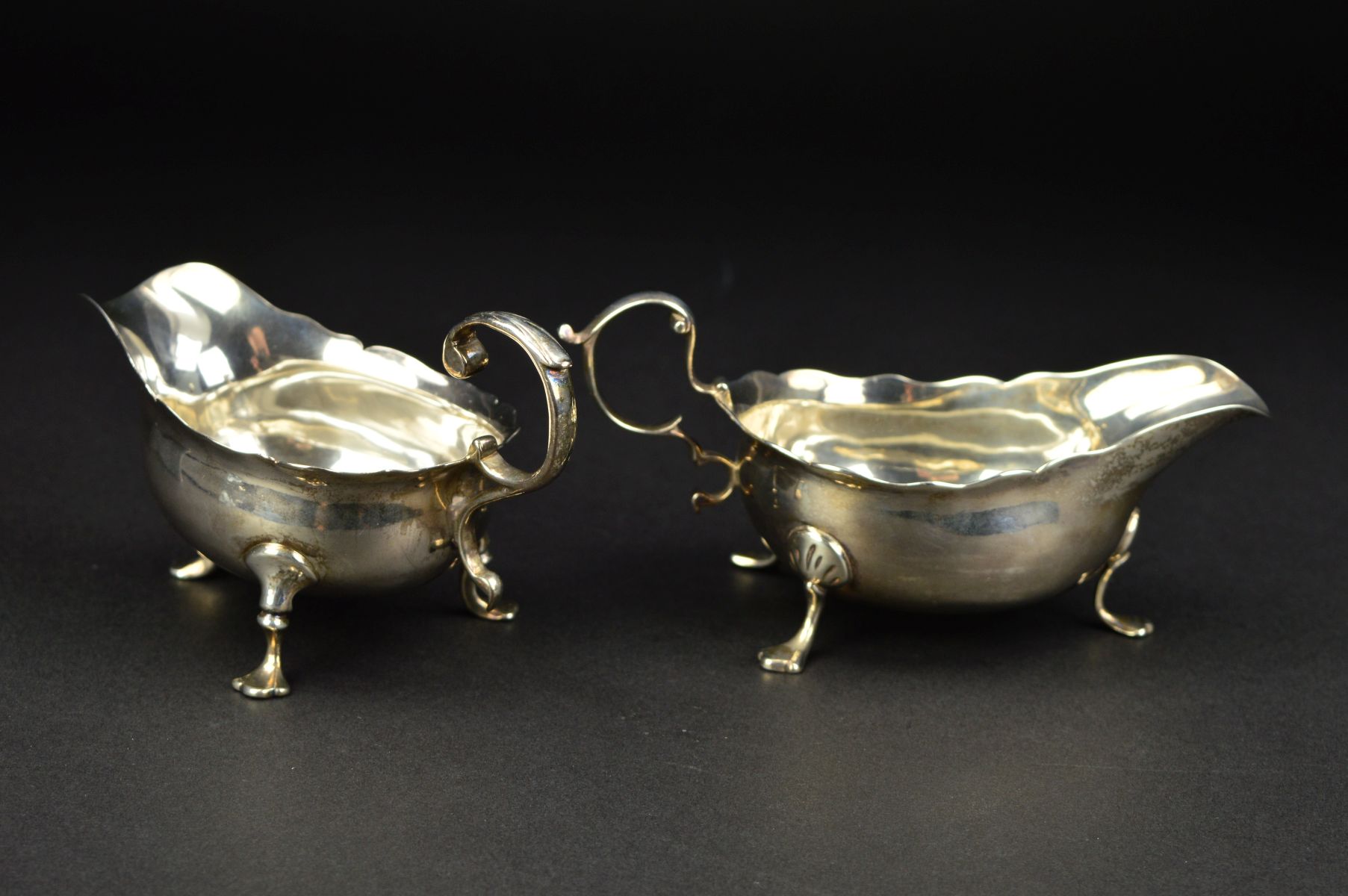 A GEORGE III NEWCASTLE SILVER SAUCEBOAT, wavy rim, 'S' scroll handle, on three cabriole legs with - Image 3 of 10
