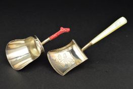 A GEORGE III SILVER CADDY SPOON, on a short coral handle, the shovel shaped bowl engraved to the