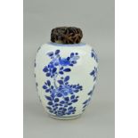 A CHINESE PORCELAIN BLUE AND WHITE DECORATED OVOID JAR, with pierced hardwood cover, depicting
