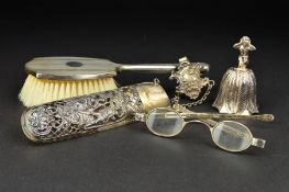 AN ELIZABETH II SILVER TABLE BELL, the handle cast as a male figure crouching holding his hands over