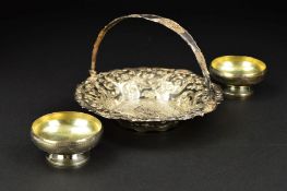 A VICTORIAN SILVER SWING HANDLED BASKET, of wavy circular form, the border embossed with foliate