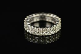 A MODERN FULL DIAMOND ETERNITY RING, two rows of modern round brilliant cut diamonds claw set,