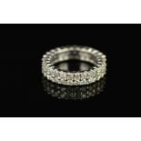 A MODERN FULL DIAMOND ETERNITY RING, two rows of modern round brilliant cut diamonds claw set,