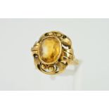 A FANCY SCROLL DESIGN CITRINE DRESS RING, ring isze N, stamped '585', approximate gross weight 4.6