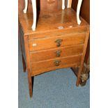 AN OAK THREE DRAWER MUSIC CABINET