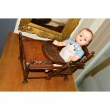 A FRENCH MADE WOODEN BABY OR DOLLS HIGH CHAIR, converts into a desk and/or a baby walker (wheels