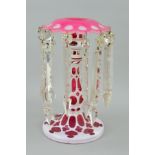 A BOHEMIAN WHITE OVERLAY ON CRANBERRY GLASS LUSTRE, with clear glass droppers, height 26cm