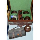 A LEATHER CASE CONTAINING FOUR LAWN BOWLS, Hemselite, size 6, measuring device, chalk, shoes, cloths