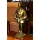 A BRASSED WROUGHT IRON COMPANION SET STAND in the form of a knight, height 65cm