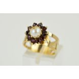 A 9CT GOLD CULTURED PEARL AND GARNET CLUSTER RING, designed as a central cultured pearl bead