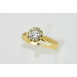 AN 18CT GOLD DIAMOND SINGLE STONE RING, the brilliant cut diamond within an illusion setting, with