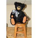 A ROBIN RIVE MODERN COLLECTORS BEAR, black plush, plastic eyes, vertical stitched nose, shaved