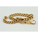 AN EARLY TO MID 20TH CENTURY GRADUATED ROSE CURB LINK BRACELET, fitted to a swivel catch,