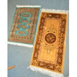 A 20TH CENTURY WOOLLEN BOKARA RUG, blue ground, together with another rug (2)