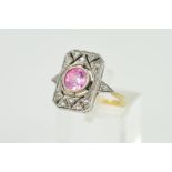 A 9CT CUBIC ZIRCONIA DRESS RING, the rectangular openwork panel set with a central circular pink