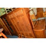 AN OAK TWO PIECE BEDROOM SUITE comprising of a two door wardrobe and a dressing table (two keys),