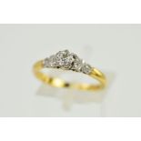 A DIAMOND RING, the brilliant cut diamond within an illusion setting to the decorative shoulders,