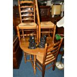 AN OAK DROP LEAF DINING TABLE and four rush seated ladder back chairs (5)