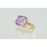 A 9CT GOLD AMETHYST AND DIAMOND RING, the rounded square shape amethyst within a four corner setting