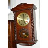 A 20TH CENTURY OAK BARLEY TWIST WALL CLOCK