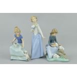 THREE NAO FIGURES, 'My Poppy' No1009 girl with dogs, height 17.5cm, Girl with Rabbits No1026, height