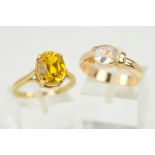 TWO 9CT GOLD GEM RINGS, the first designed as an oval synthetic yellow sapphire within a four claw